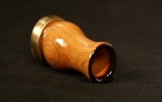 Custom wooden game call with a clear lacquer finish and ferrule, available in bulk for manufacturers and production runs.
